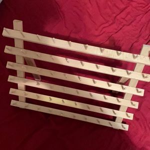 wooden rack. braiding or thread.